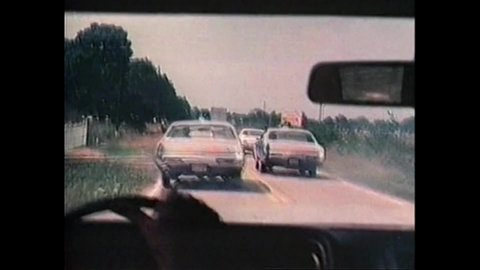CIRCA 1977 - In this crime movie, policemen driving after wanted drug dealers crash into trucks and other obstacles.