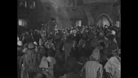 CIRCA 1923 - In this silent movie adaptation of the Hunchback of Notre Dame, Clopin rouses his men to save Esmeralda from Notre Dame.