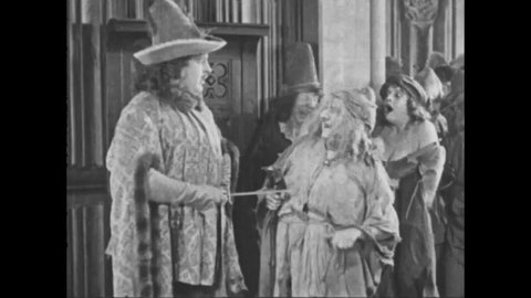 CIRCA 1923 - In this silent movie adaptation of the Hunchback of Notre Dame, old beggar women mock an aristocratic guard.