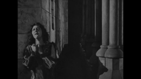 CIRCA 1923 - In this silent movie adaptation of the Hunchback of Notre Dame, a dying Quasimodo is heartbroken to see Esmeralda and Phoebus embrace.