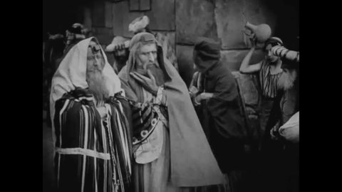 CIRCA 1916 - In this silent epic movie, a Pharisee pauses activity in a Judean marketplace so he can pray.