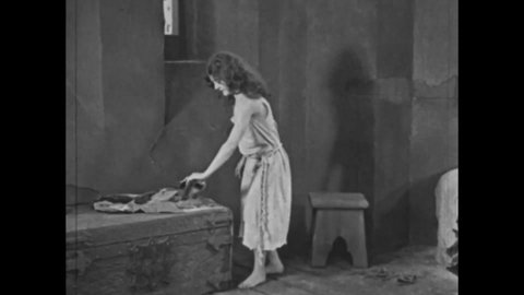 CIRCA 1923 - In this adaptation of the Hunchback of Notre Dame, Esmeralda awakens in the cathedral and Quasimodo joyfully rings the bells.