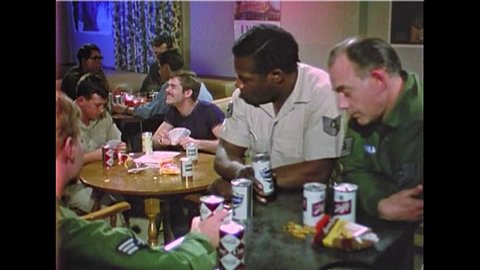 CIRCA 1960s - Soldiers drink in a Southeast Asian bar and play Gin rummy, in 1969.