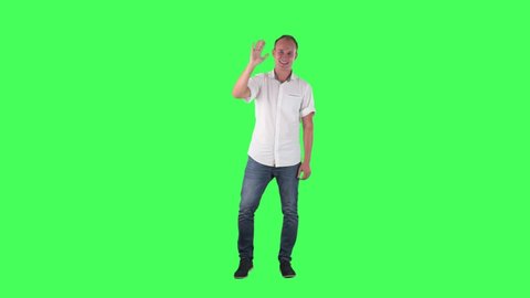 Cheerful young business man waving hand greeting hello. Full body on green screen chroma key background.