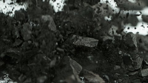Super Slow Motion Shot of Coal and Black Powder Falling on White Background at 1000 fps.