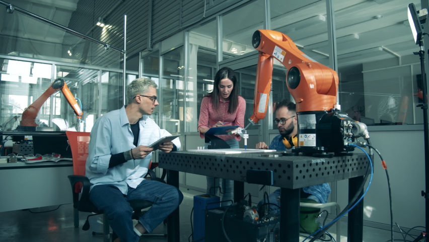 Group of researchers are working with a high-tech robotic arm