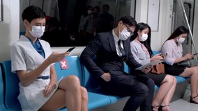 business people man and woman with face mask use smartphone and sit metro train subway with people traveling public transportation. Concept new normal life with Pandemic covid 19 Corona Virus.