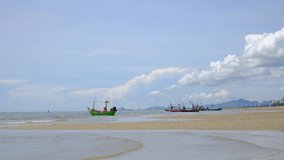 Small fishing boats on shore, with a beautiful cloud and sunshine backdrop, relaxing color and atmosphere on tropical beach, photo for content or travel banner, 4K UHD, Video Clip