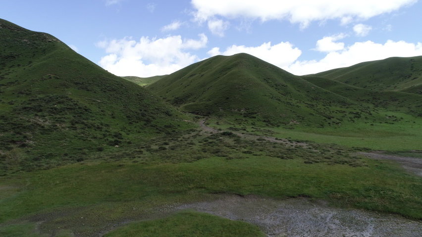High altitude mountains with grassland landscape