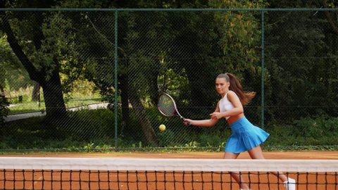 A woman plays tennis with funny fails in slow motion