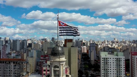 Aerial view of São Paulo city flag at the top of Town with beauty sky. Cityscape view. Great landscape. Urban scene. Sao Paulo flag. City Life scenery. Aerial landscape of the City Life scenery.