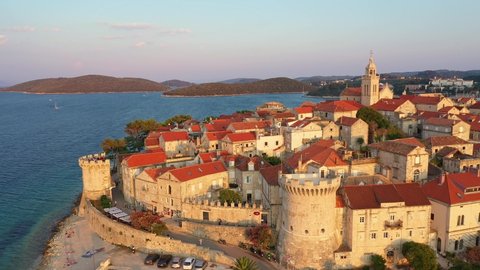 Aerial view of the Korcula old town in Croatia by the Adriatic sea in the Balkans with a backward and upward motion