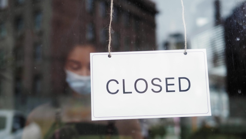 cafe or restaurants and business reopen after coronavirus quarantine is over. woman with face mask turning a sign on a door shop. small business after covid lockdown. business open sign. Royalty-Free Stock Footage #1059638705