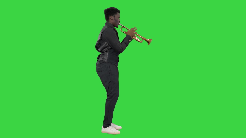 African american musician playing the trumpet expressively on a Green Screen, Chroma Key.