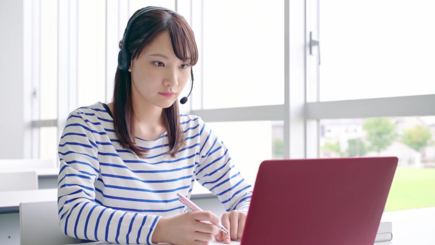Young asian female student taking online lessons. Royalty-Free Stock Footage #1059655013