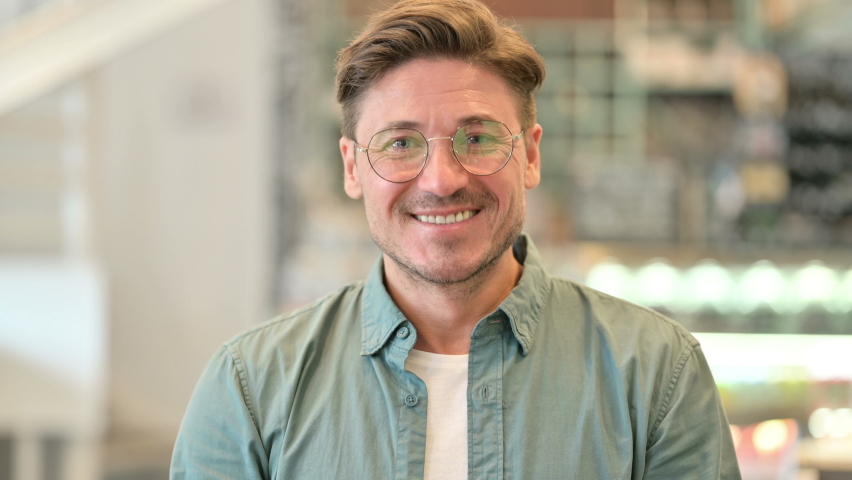 Portrait of Positive Middle Aged Man saying Yes by Shaking Head