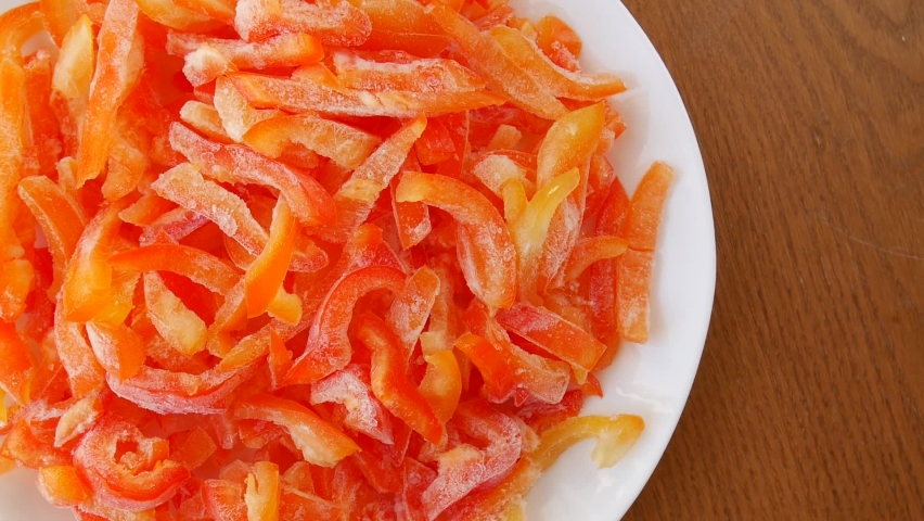 Frozen red peppers on a plate.