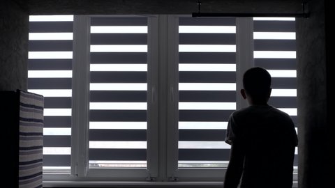 Man installing cassette roller blinds on windows
