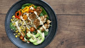 Rotating Southwest Chicken Salad on a Wooden Background