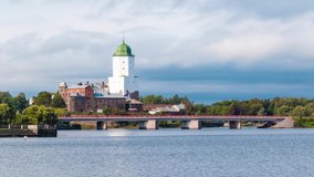 Time-lapse video with zooming. Beautiful view of the Vyborg Castle and the Petrovsky Bridge in cloudy day, Vyborg, Leningrad Oblast, Russia
