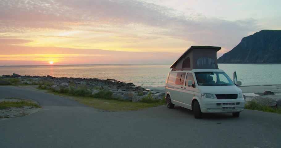 Caravan on sea shore at dusk or sunset. vehicle camping near the sea and mountains. Adventure, travel with motor home.  Royalty-Free Stock Footage #1059673667