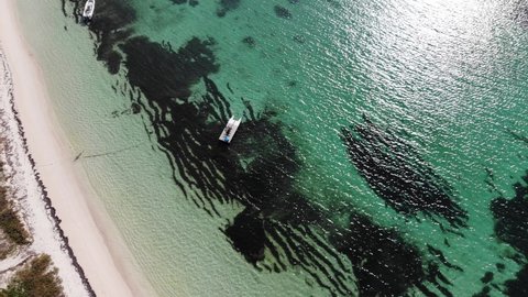 High Aerial view of a white sandy beach. Turquoise ocean sea water. 