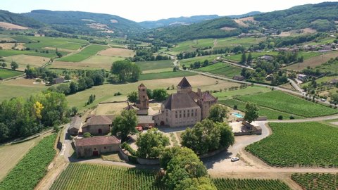 Vineyards and Pierreclos castle in French Mâconnais countryside, near Mâcon, drone aerial view