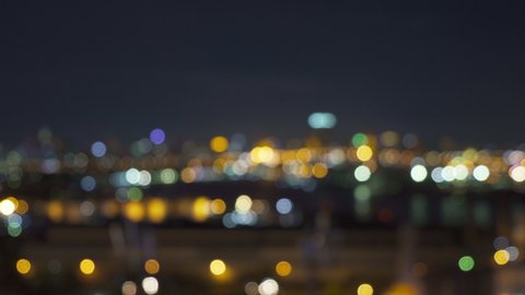 Bokeh abstract background of skyscraper buildings in Bangkok city, Thailand with lights, Blurry photo at night time. Cityscape.