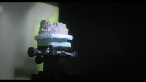 3D scanning of a plaster cast of the jaw. Modern dental technology. Ultraviolet rays travel through the teeth.