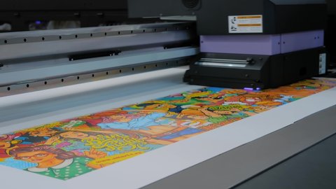 MOSCOW, RUSSIA - JANUARY 5, 2020: Advertising Exhibition. Large format colorful printing - UV digital flatbed printer during work at printing house, trade show