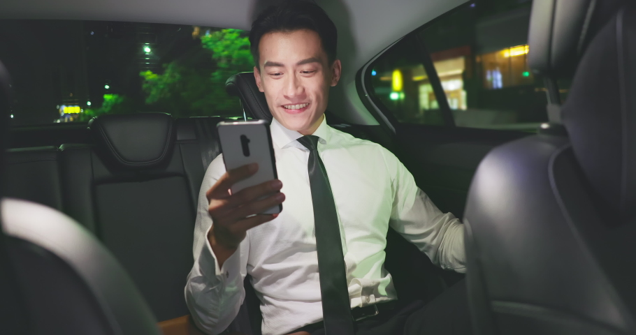 asian successful businessman use smart phone in the taxi at night Royalty-Free Stock Footage #1059696884