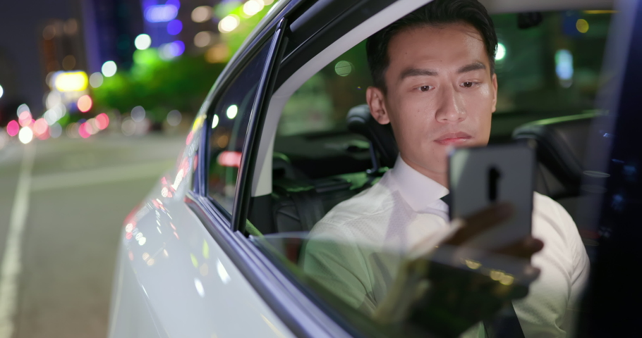 asian successful businessman use smart phone in the car at night Royalty-Free Stock Footage #1059696887