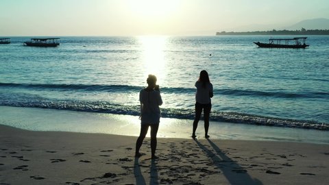 Bermuda islands, Best friends on the vacation taking photos with the smartphone on the sandy beach