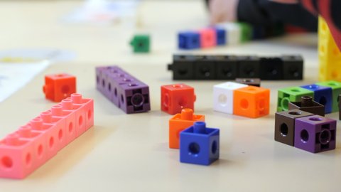 Young School Student Lining Up Colored Blocks In Class, CLOSE UP