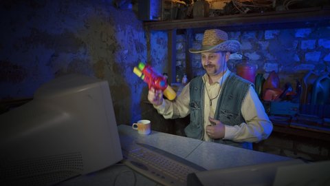 A cowboy in a straw hat near the computer raises his thumbs up. A funny man with a mustache plays with a child's weapon. Old garage. Vintage style, retro