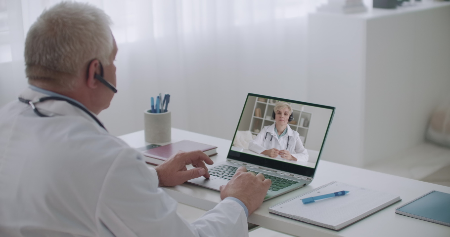 Two doctors are communicating online by videochat, remote communication technology, distance education | Shutterstock HD Video #1059702809