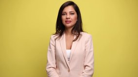 Young happy businesswoman is jumping and being excited, dancing around and having a good time, clapping hands and raising her arms in the air with alot of joy on yellow background - Powered by Shutterstock - Get 15% off with code: PIKWIZARD15