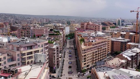 Aerial view center of Yerevan. Northern avenue in capital of Armenia. Drone fly over modern buildings in the city. An aerial shot of the center of the city of Yerevan, Armenia.