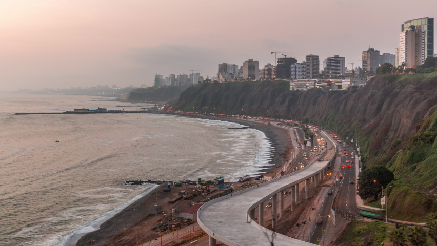 Aerial view of Lima's Coastline in the neighborhood of Miraflores day to night transition timelapse, Lima, Peru. Road traffic with junction and beach with ocean from Husares De Junin waterfront Royalty-Free Stock Footage #1059711416