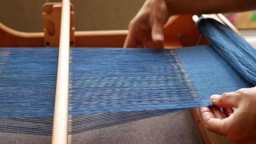 A women's hands working on a weaving loom, Blue yarns, Textile industry | Shutterstock HD Video #1059712751
