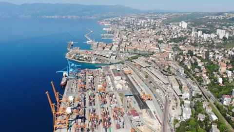 Aerial view of cargo terminal with Rijeka city in the background, Croatia - beautiful panoramic view