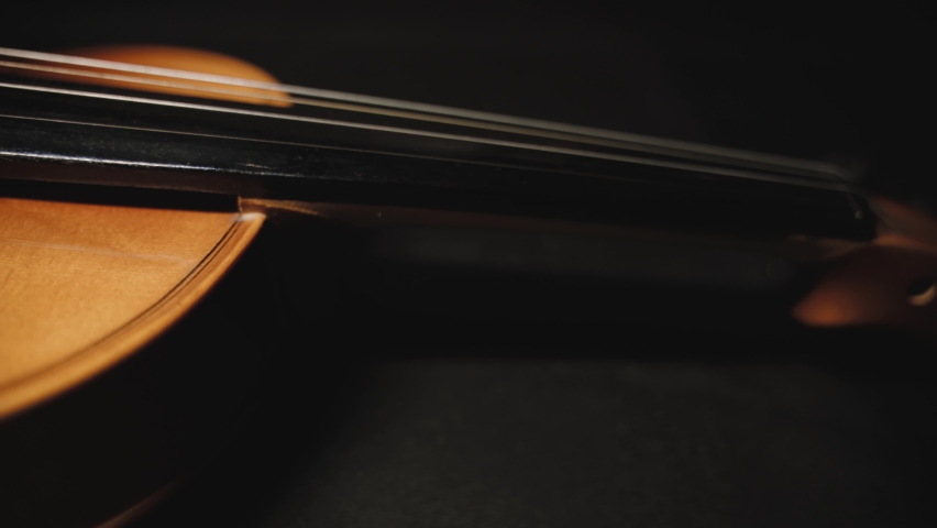 Close up left truck shot of antique violin isolated on dark background. Shallow DOF Royalty-Free Stock Footage #1059714023