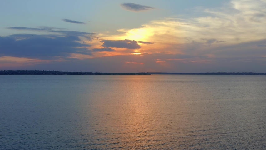 Picturesque sunset. Beautiful sky with clouds over river
