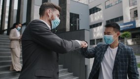 Two businessmen in medical mask meet each other and go to work together in modern office building. Quarantine successful respiratory protection manager coronavirus. Slow motion - Powered by Shutterstock - Get 15% off with code: PIKWIZARD15