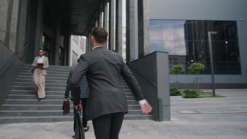 Close up shot back businessman walking hurry up the stairs moving people around. Worker confident running career manager. Slow motion Royalty-Free Stock Footage #1059722420
