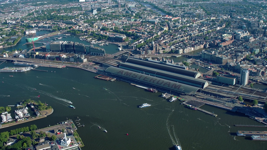 Aerial view of Downtown Amsterdam, Netherlands. Many famous buildings and canals. Amsterdam central station. 