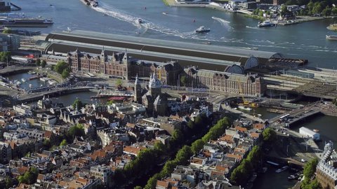 
Aerial view of the famous Amsterdam Centraal Station, the largest railway station in Netherlands. Many ferries in the IJ. 