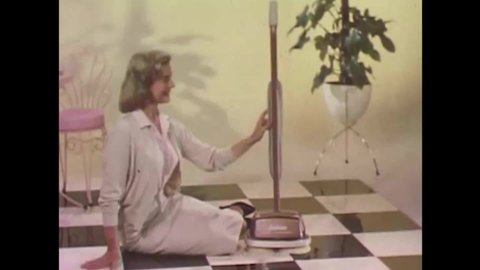 CIRCA 1960s - An American housewife prefers Sunbeam's floor conditioner to wax and polish her linoleum and wooden floors.