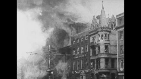 CIRCA 1920s - Burning buildings, a shot up storefront, and crowds around armed guards in the Irish War of Independence, in 1920.