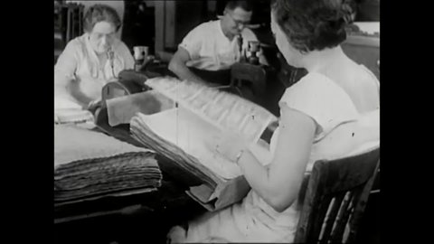 CIRCA 1933 - Men and women are seen working at the Bureau of Printing and Engraving, making money and stamps.